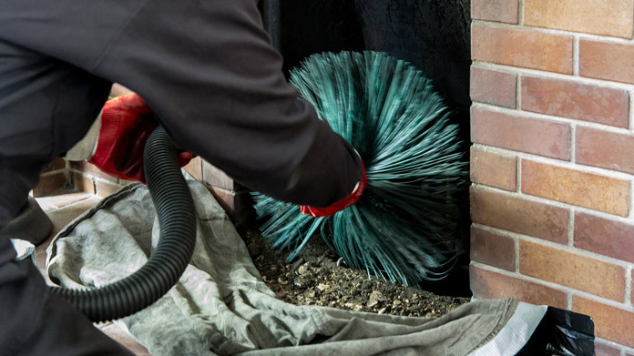 cleaning fireplace and chimney with chimney brush