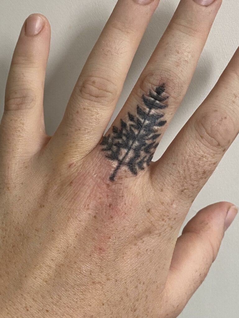 Finger tattoo of a pine tree
