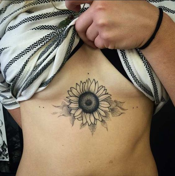 Sunflower design under breast tattoo