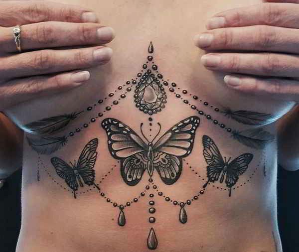 Chandelier tattoo beneath the breast